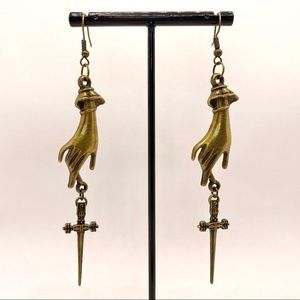 Victorian hand with thin dagger earrings